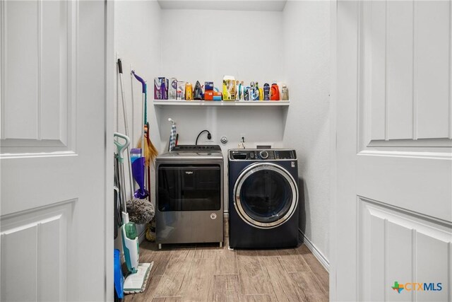 7511 Wind Chime Way, Temple, TX 76502 - laundry area with washer and clothes dryer and light wood finished floors