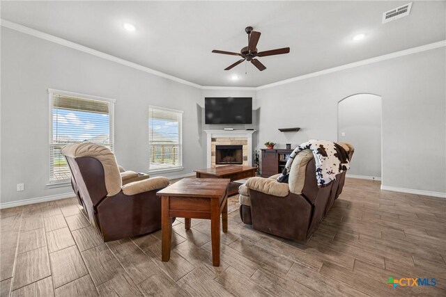 7511 Wind Chime Way, Temple, TX 76502 - living area featuring ceiling fan, crown molding, a stone fireplace, wood tiled floors, and recessed lighting