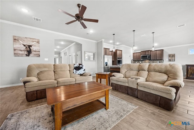 7511 Wind Chime Way, Temple, TX 76502 - living area with arched walkways, a ceiling fan, light wood-style floors, ornamental molding, and recessed lighting