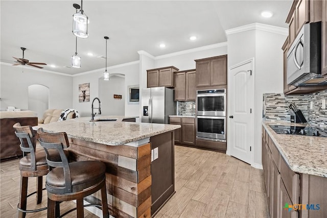 7511 Wind Chime Way, Temple, TX 76502 - kitchen with stainless steel appliances, recessed lighting, a ceiling fan, tasteful backsplash, and light stone countertops