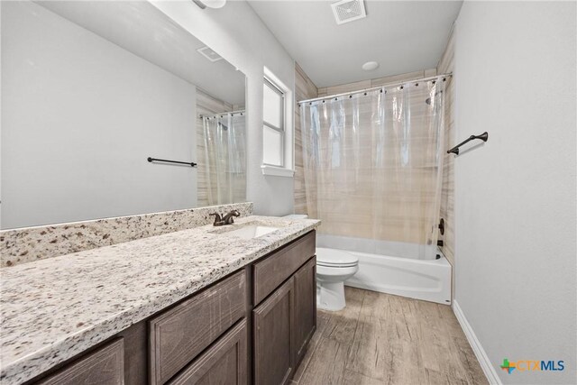 7511 Wind Chime Way, Temple, TX 76502 - full bathroom featuring wood finished floors, vanity, and shower / tub combo with curtain