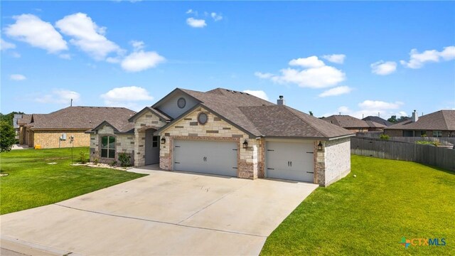 7511 Wind Chime Way, Temple, TX 76502 - french country home featuring an attached garage, concrete driveway, stone siding, and a chimney