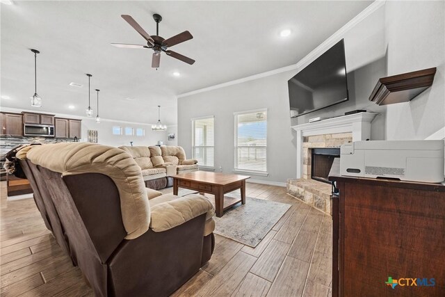 7511 Wind Chime Way, Temple, TX 76502 - living room with a ceiling fan, recessed lighting, healthy amount of natural light, ornamental molding, and light wood-style flooring