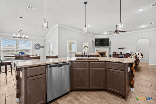 7511 Wind Chime Way, Temple, TX 76502 - kitchen featuring stainless steel dishwasher, ceiling fan, healthy amount of natural light, ornamental molding, and open floor plan