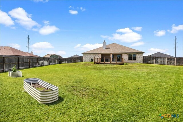 7511 Wind Chime Way, Temple, TX 76502 - back of house with a fenced backyard, a wooden deck, a chimney, and brick siding