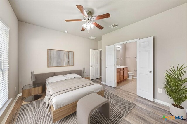 bathroom with tile patterned floors, tiled shower / bath combo, ceiling fan, and vanity