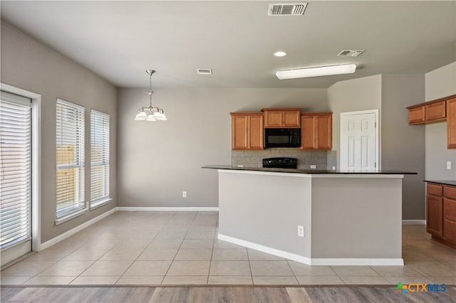 kitchen with a chandelier, stove, backsplash, and plenty of natural light