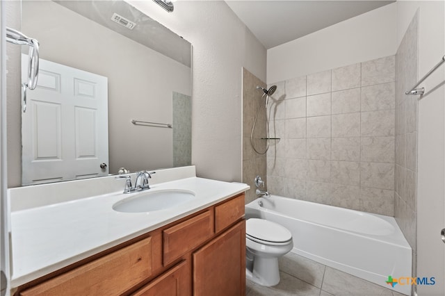 full bathroom with tile patterned flooring, vanity, toilet, and tiled shower / bath