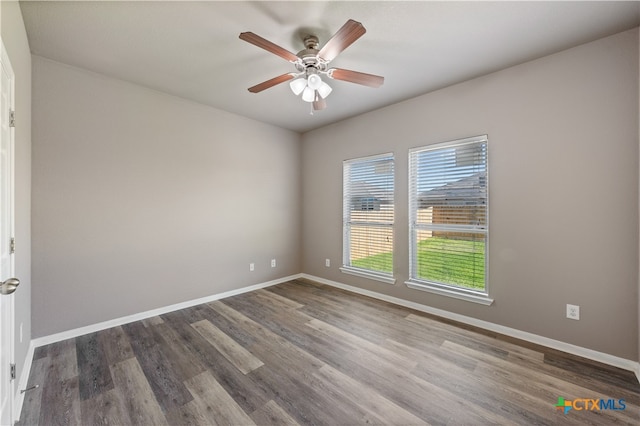 unfurnished room featuring ceiling fan and dark hardwood / wood-style flooring