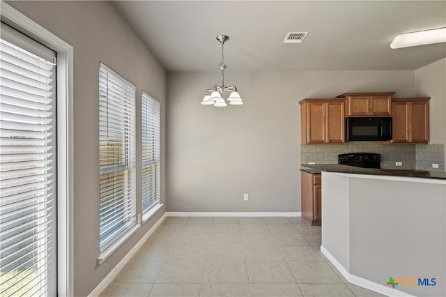 kitchen featuring an inviting chandelier, black appliances, decorative light fixtures, decorative backsplash, and plenty of natural light