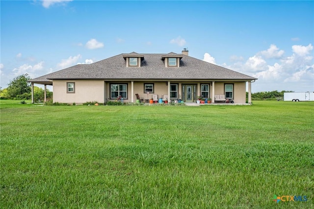 196 Garza Rd, Port Lavaca, TX 77979 - back of house featuring a chimney, a yard, stucco siding, and a porch