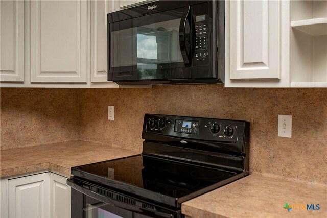 196 Garza Rd, Port Lavaca, TX 77979 - kitchen featuring black appliances, decorative backsplash, white cabinetry, and light countertops