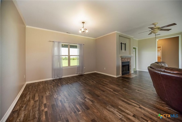 196 Garza Rd, Port Lavaca, TX 77979 - unfurnished living room with dark wood-type flooring, a chandelier, a tile fireplace, ornamental molding, and a ceiling fan