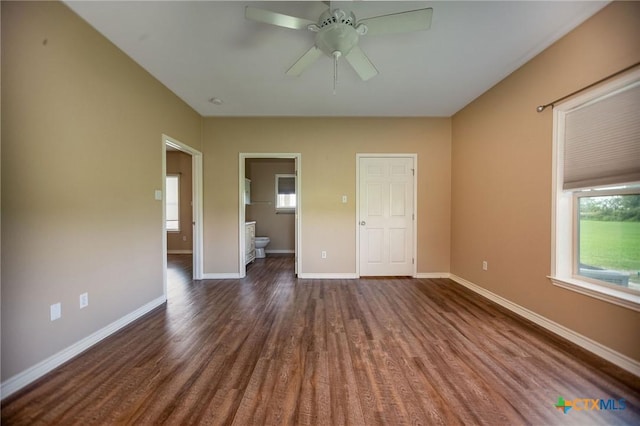 196 Garza Rd, Port Lavaca, TX 77979 - unfurnished bedroom with dark wood-style flooring, ensuite bath, and a ceiling fan