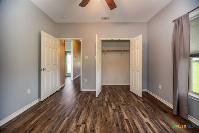 196 Garza Rd, Port Lavaca, TX 77979 - unfurnished bedroom with dark wood-style flooring, a closet, and a ceiling fan
