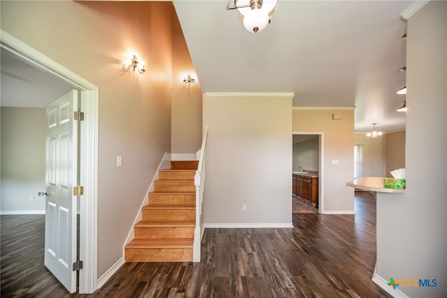 196 Garza Rd, Port Lavaca, TX 77979 - stairway with wood finished floors, ornamental molding, and a chandelier