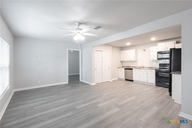 1445 Hillview Ave, New Braunfels, TX 78130 - kitchen with black appliances, white cabinetry, baseboards, a sink, and recessed lighting