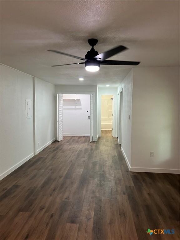 empty room featuring ceiling fan, dark hardwood / wood-style flooring, and a textured ceiling