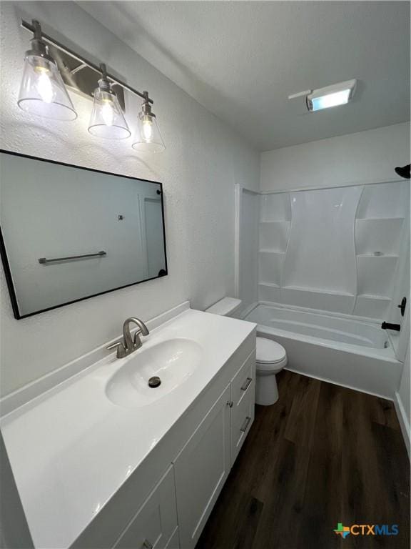 full bathroom featuring toilet, shower / washtub combination, vanity, and hardwood / wood-style flooring