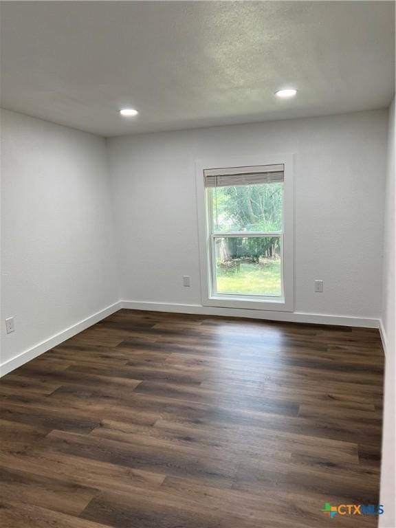 spare room featuring dark hardwood / wood-style flooring