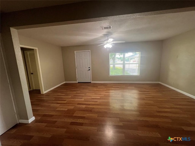 unfurnished room with dark hardwood / wood-style floors and ceiling fan