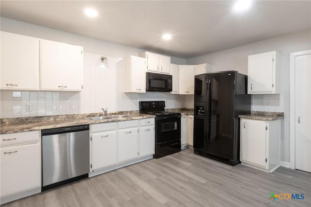 1445 Hillview Ave, New Braunfels, TX 78130 - kitchen with black appliances, a sink, light wood-type flooring, white cabinetry, and backsplash