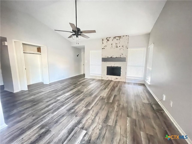 420 Londonderry Dr, Victoria, TX 77901 - unfurnished living room with a ceiling fan, dark wood-style flooring, baseboards, vaulted ceiling, and a fireplace