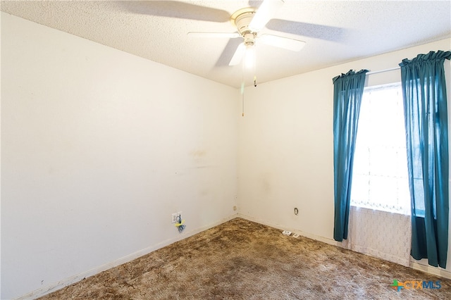 spare room with carpet, a textured ceiling, and ceiling fan