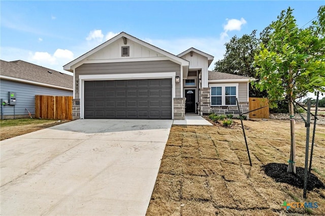 9820 Tarabon Dr, Killeen, TX 76542 - view of front of property featuring board and batten siding, stone siding, driveway, and a garage