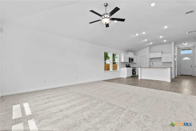 9820 Tarabon Dr, Killeen, TX 76542 - unfurnished living room featuring lofted ceiling, light carpet, recessed lighting, and ceiling fan