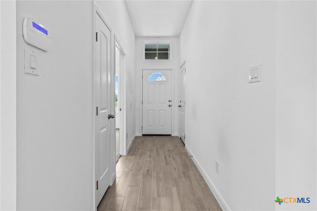 9820 Tarabon Dr, Killeen, TX 76542 - doorway to outside featuring baseboards and light wood-style floors