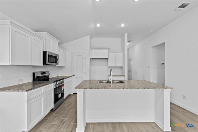 9820 Tarabon Dr, Killeen, TX 76542 - kitchen with appliances with stainless steel finishes, white cabinetry, light stone countertops, recessed lighting, and lofted ceiling