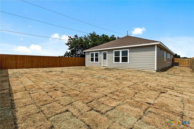 9820 Tarabon Dr, Killeen, TX 76542 - rear view of house with a fenced backyard and roof with shingles