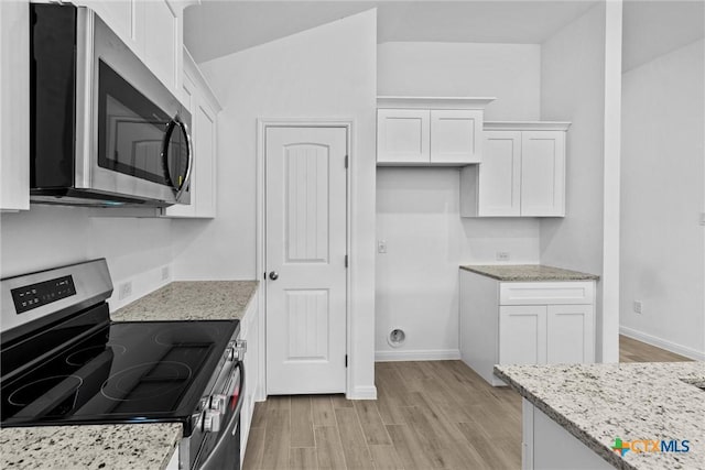 9820 Tarabon Dr, Killeen, TX 76542 - kitchen with stainless steel appliances, white cabinets, light wood-type flooring, light stone countertops, and lofted ceiling