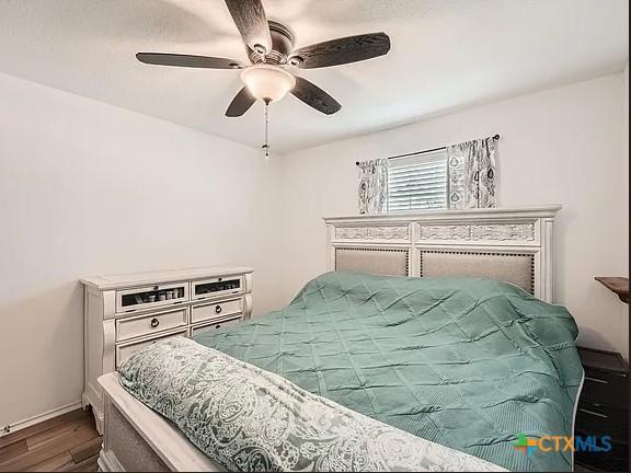 13517 Knights Branch Dr, Elgin, TX 78621 - bedroom with dark wood-style flooring and a ceiling fan