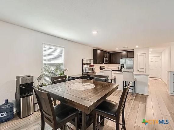 13517 Knights Branch Dr, Elgin, TX 78621 - dining room with light wood-style flooring and recessed lighting