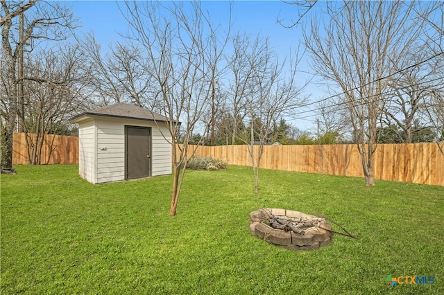 view of yard featuring a shed and a fire pit