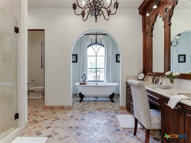 full bathroom featuring vanity, shower with separate bathtub, an inviting chandelier, and toilet