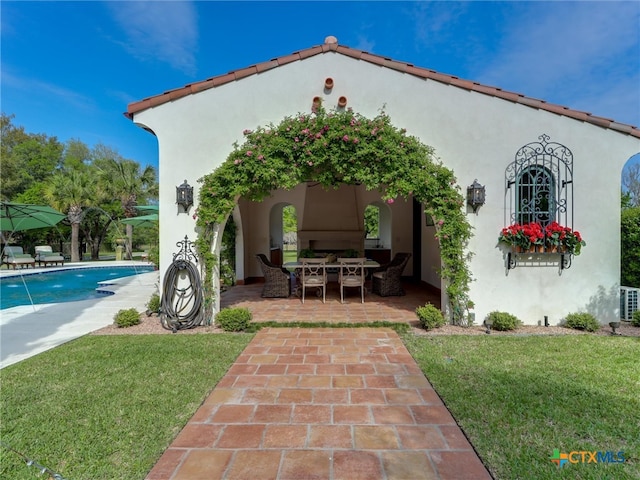 exterior space featuring a lawn and a patio