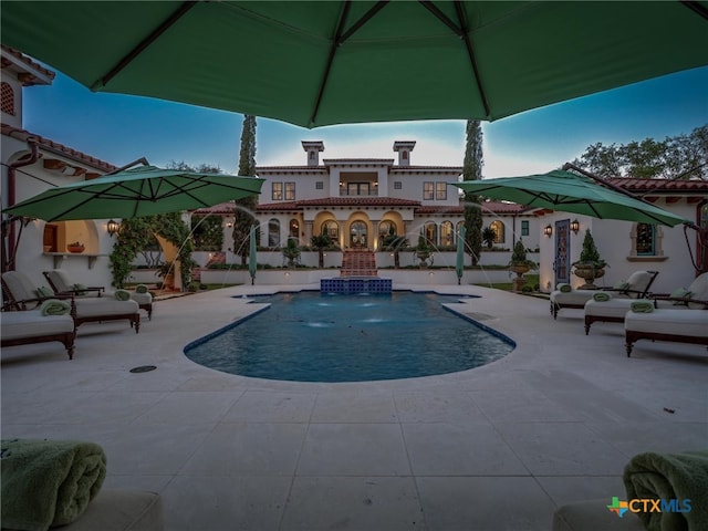 view of swimming pool with a patio and pool water feature