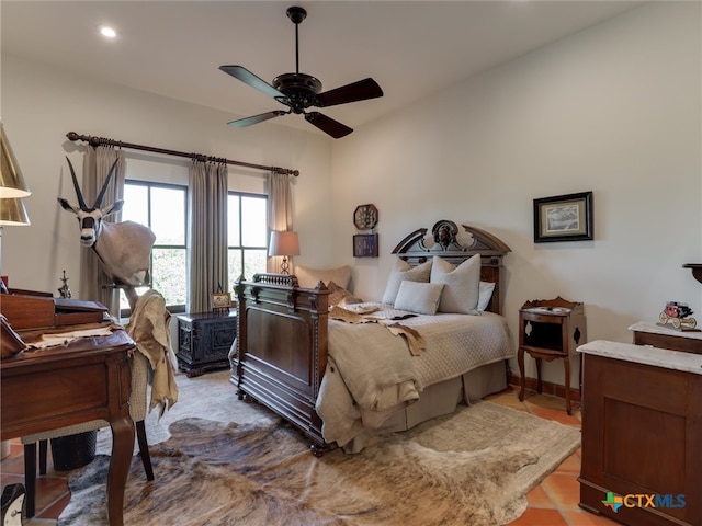 tiled bedroom with vaulted ceiling and ceiling fan