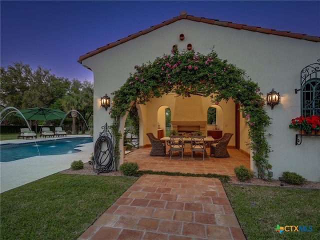 exterior space with a patio and pool water feature