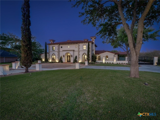 mediterranean / spanish house featuring a front yard