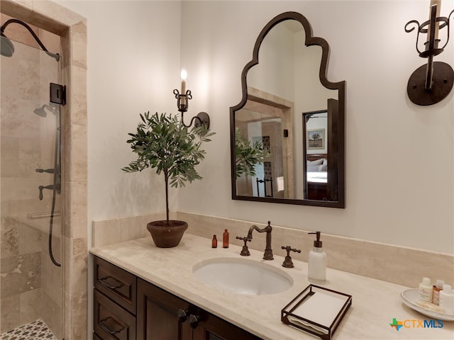 bathroom with a shower with door and vanity