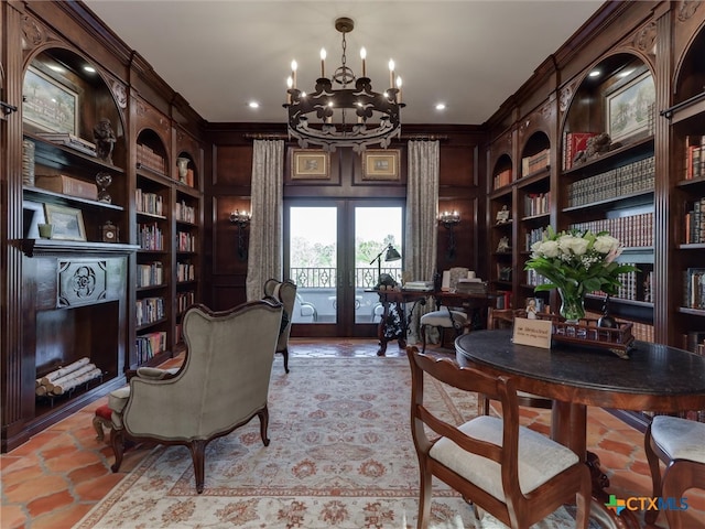 office featuring built in features, crown molding, an inviting chandelier, and french doors