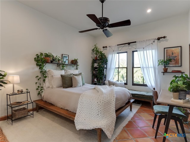 tiled bedroom featuring ceiling fan