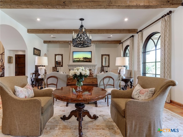 tiled living room featuring beamed ceiling and a chandelier