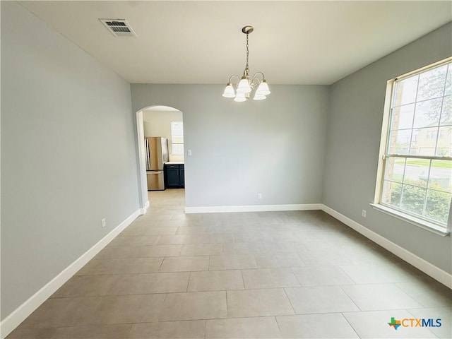 4302 Jack Barnes Ave, Killeen, TX 76549 - empty room featuring arched walkways, a chandelier, and light tile patterned floors
