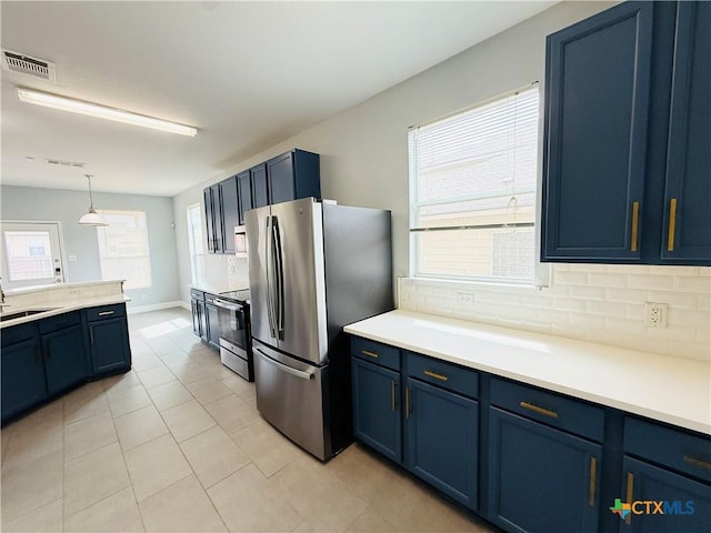 4302 Jack Barnes Ave, Killeen, TX 76549 - kitchen with stainless steel appliances, blue cabinets, decorative backsplash, and light countertops