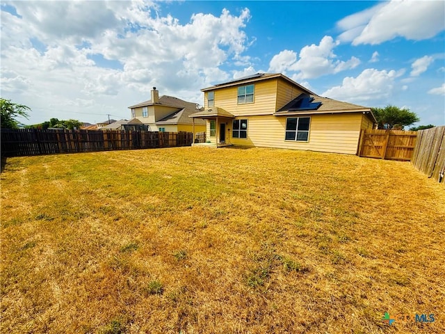 4302 Jack Barnes Ave, Killeen, TX 76549 - rear view of house with solar panels and a fenced backyard